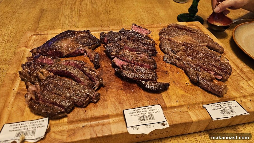 Three Steaks on a Wooden Board