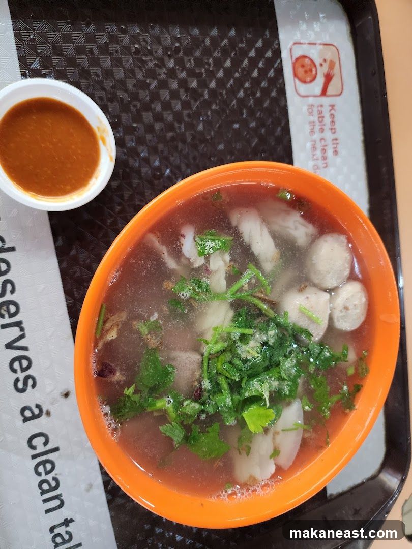 Bowl of soup with meatballs and herbs