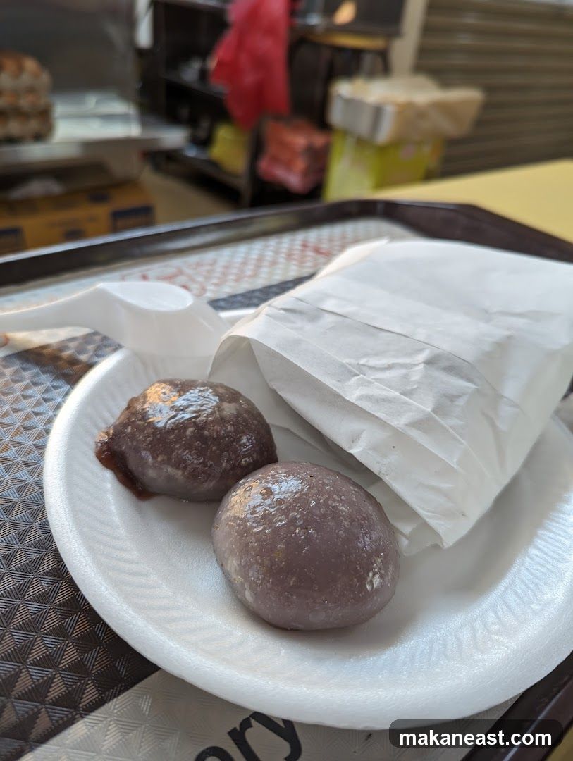 Two purple mochi balls on a plate