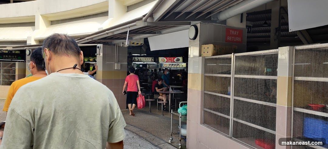 Food court with people queuing and dining