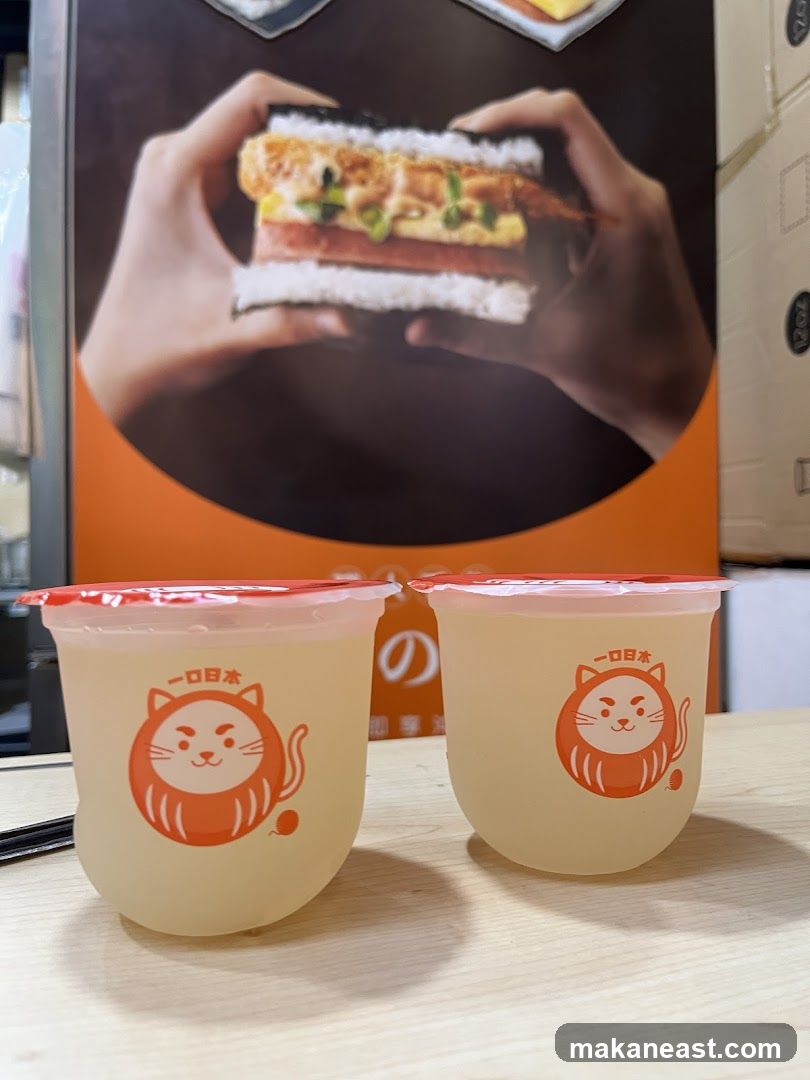 Two drinks with a promotional image in the background