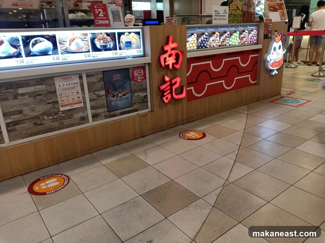 Food stall with displayed food items and prices