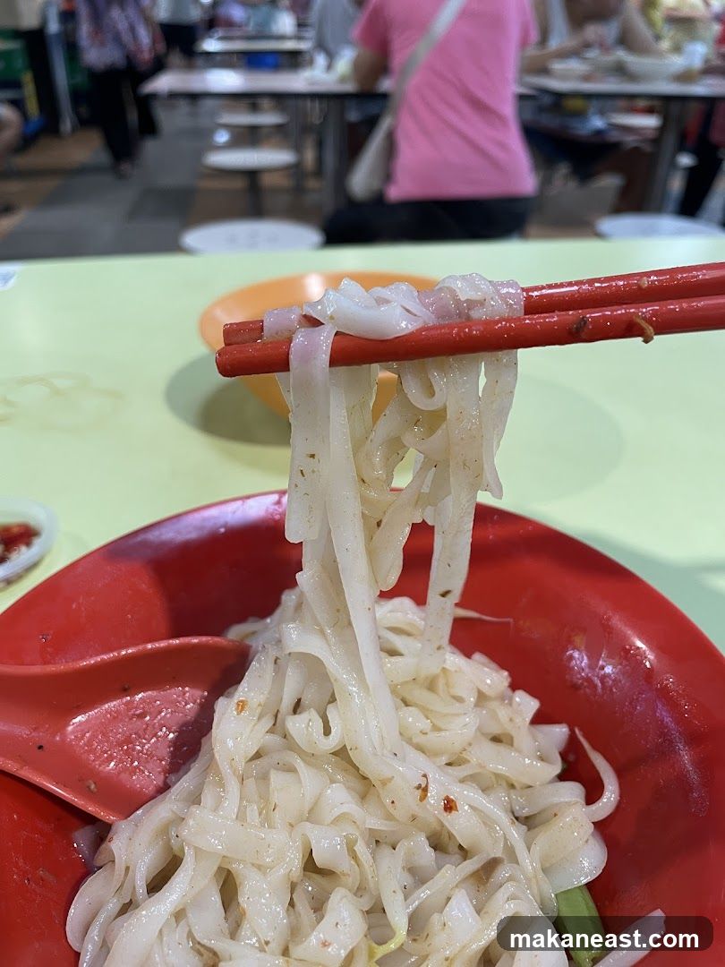 Noodles being lifted with chopsticks