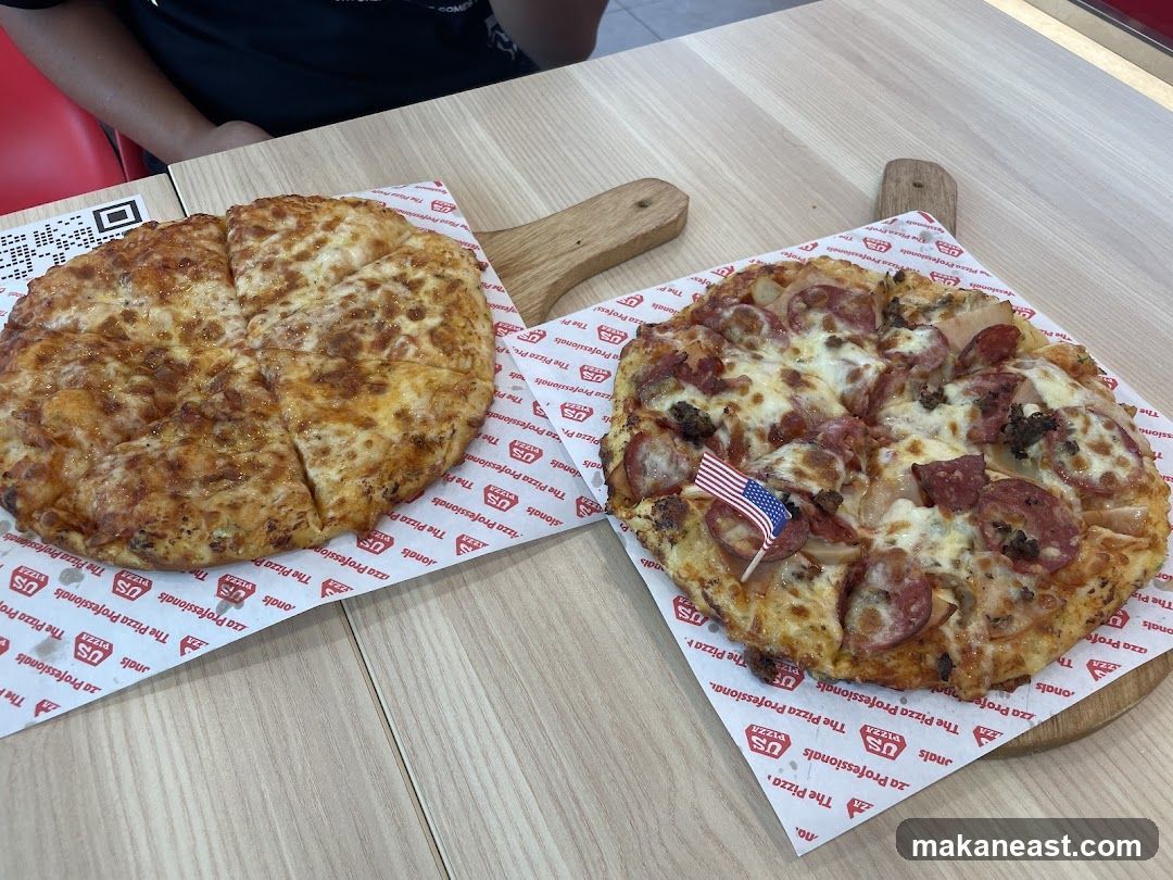 Two Pizzas on Wooden Boards