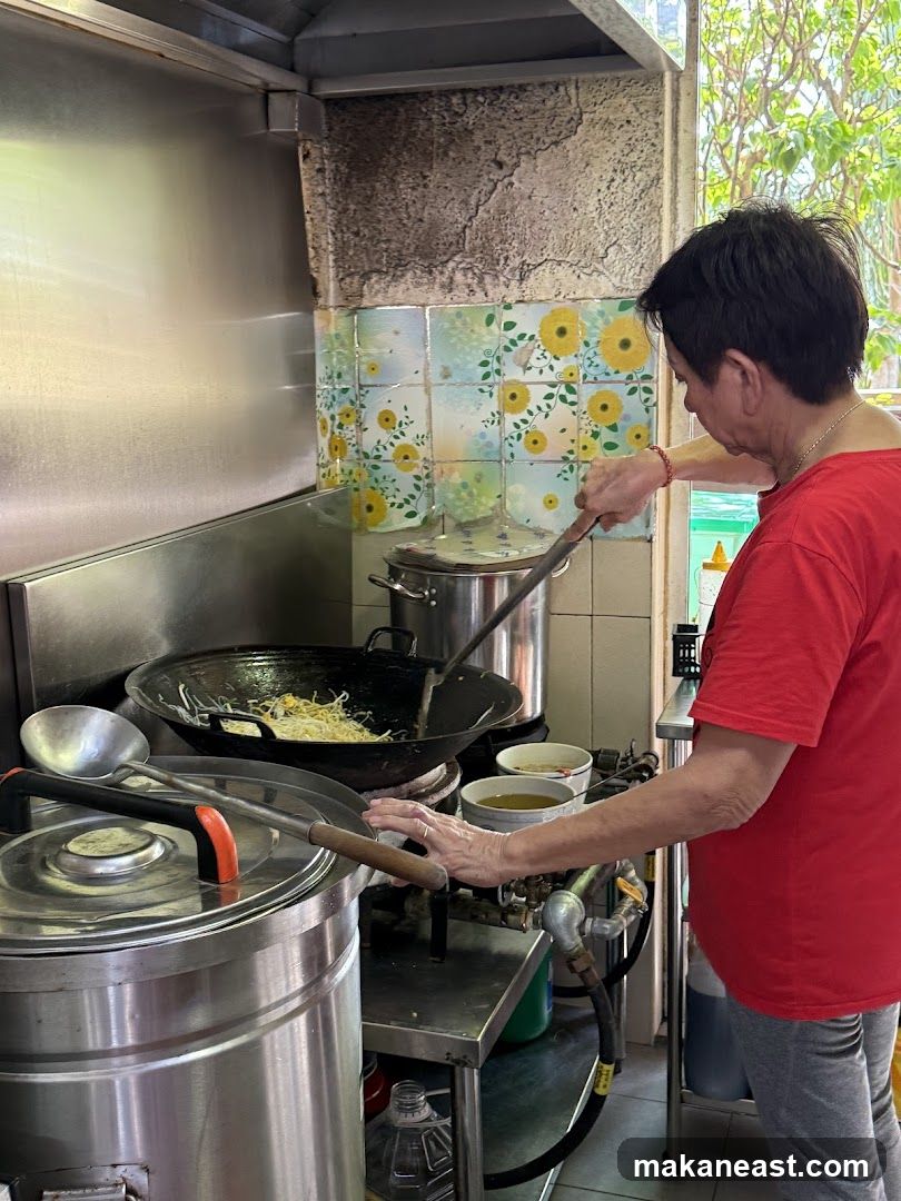 Cook preparing food in a wok