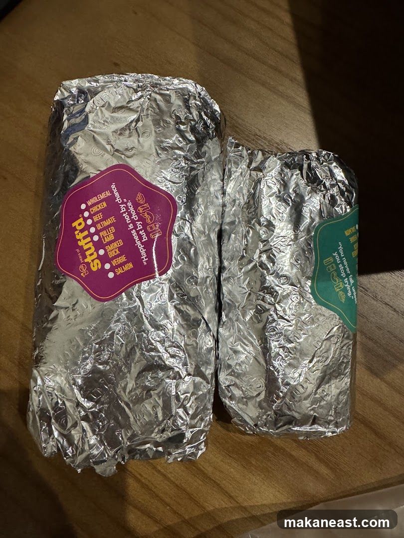 Two foil-wrapped burritos