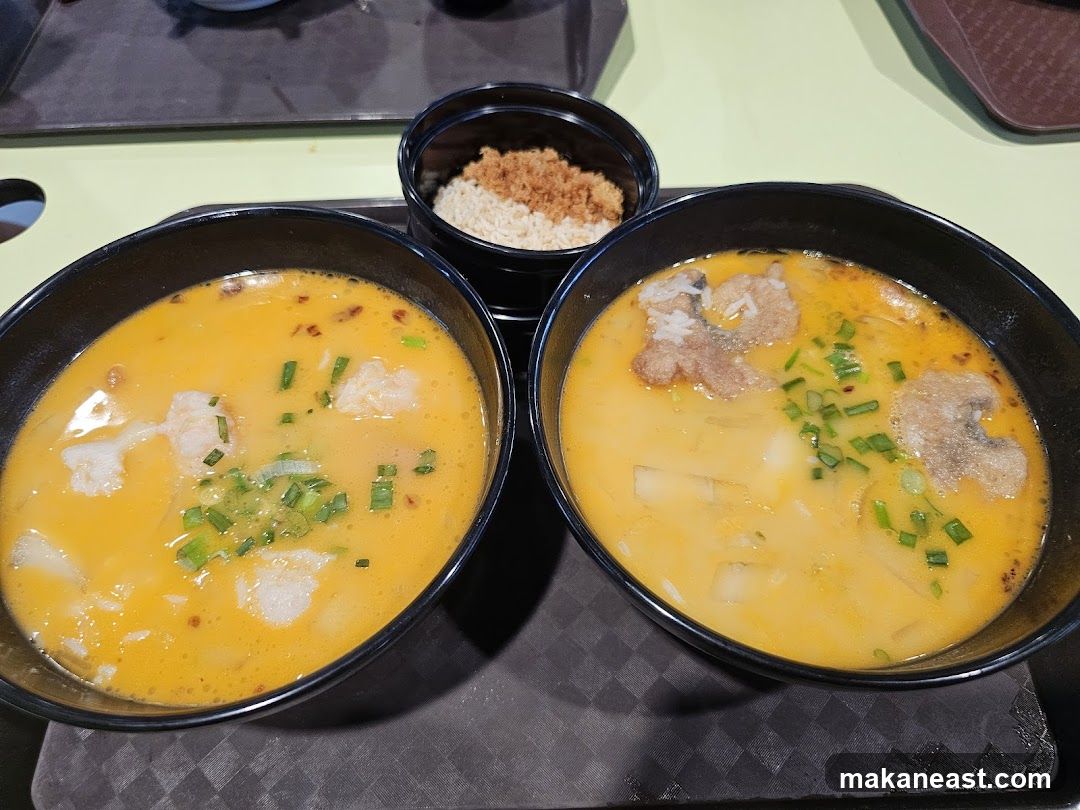Two bowls of fish soup with rice