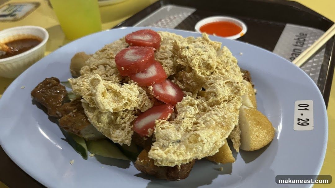 Plate of Fried Food with Sliced Fish Cake and Dipping Sauce