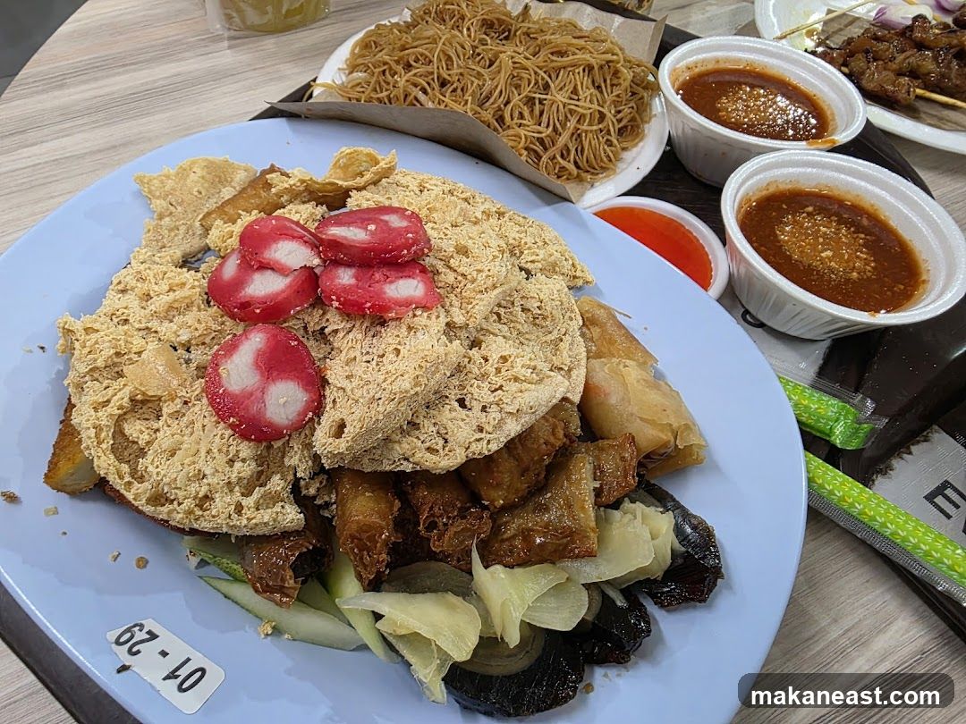 Plate of food with noodles and dipping sauces