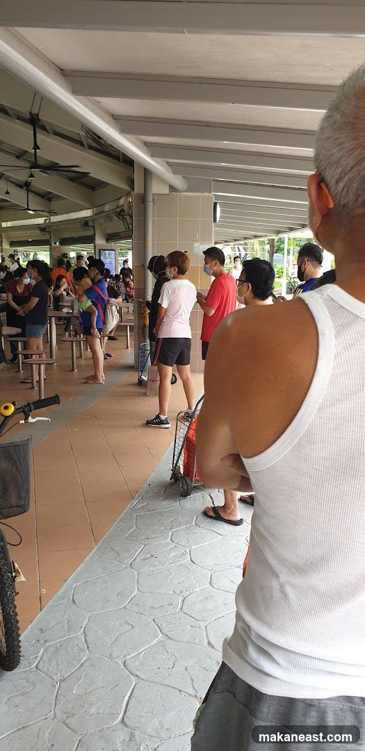 People queuing at an outdoor food court