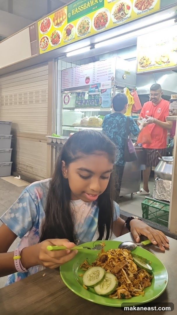Girl Eating Noodles at a Food Stall