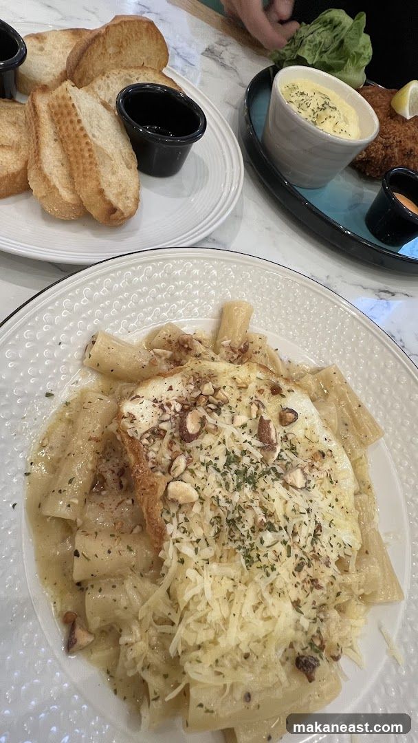 Pasta dish with bread and a side dish