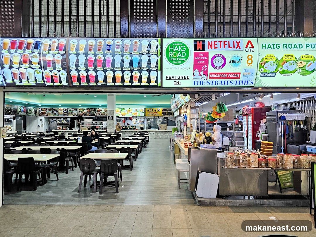 Food court with various food stalls and seating area