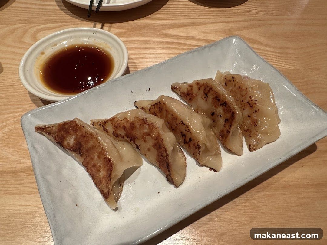 Pan-fried dumplings with dipping sauce