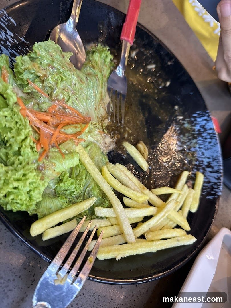 Partially Eaten Salad and Fries