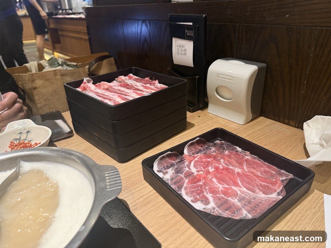 Table setting with thinly sliced meat and hot pot
