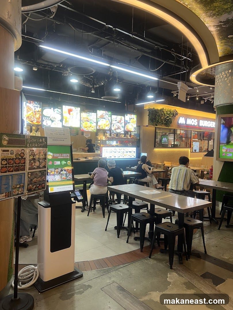 Food court with dining tables and various food stalls