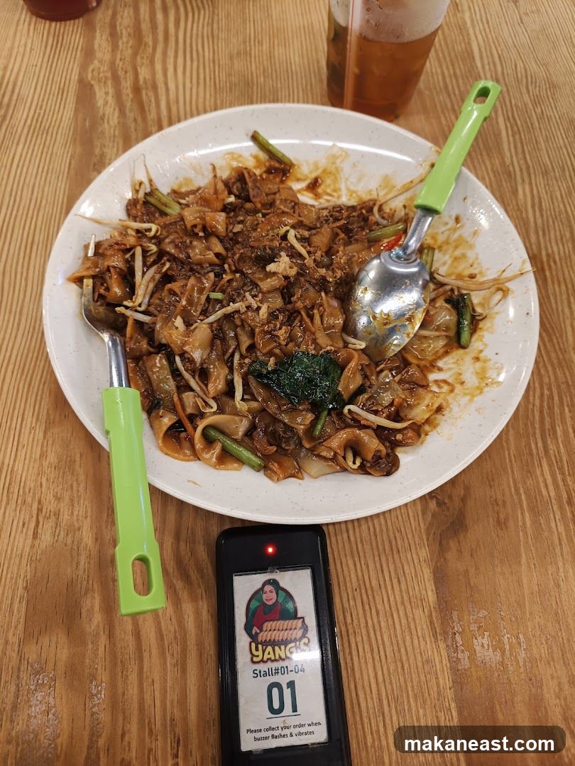 Plate of Char Kway Teow with a Buzzer