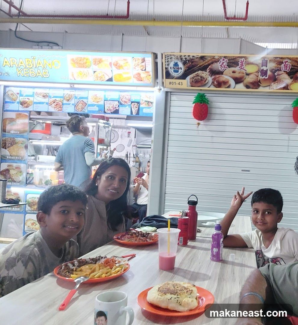Family enjoying a meal at a food stall