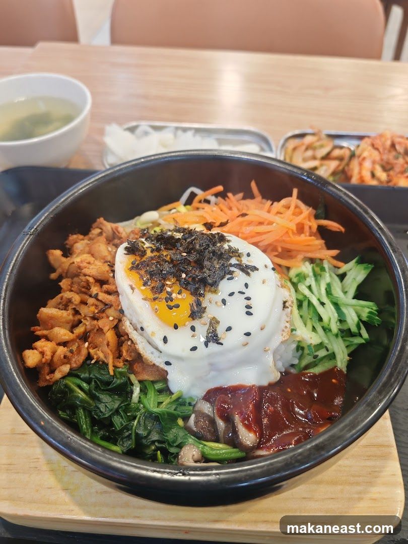 Bibimbap with a side of soup and kimchi
