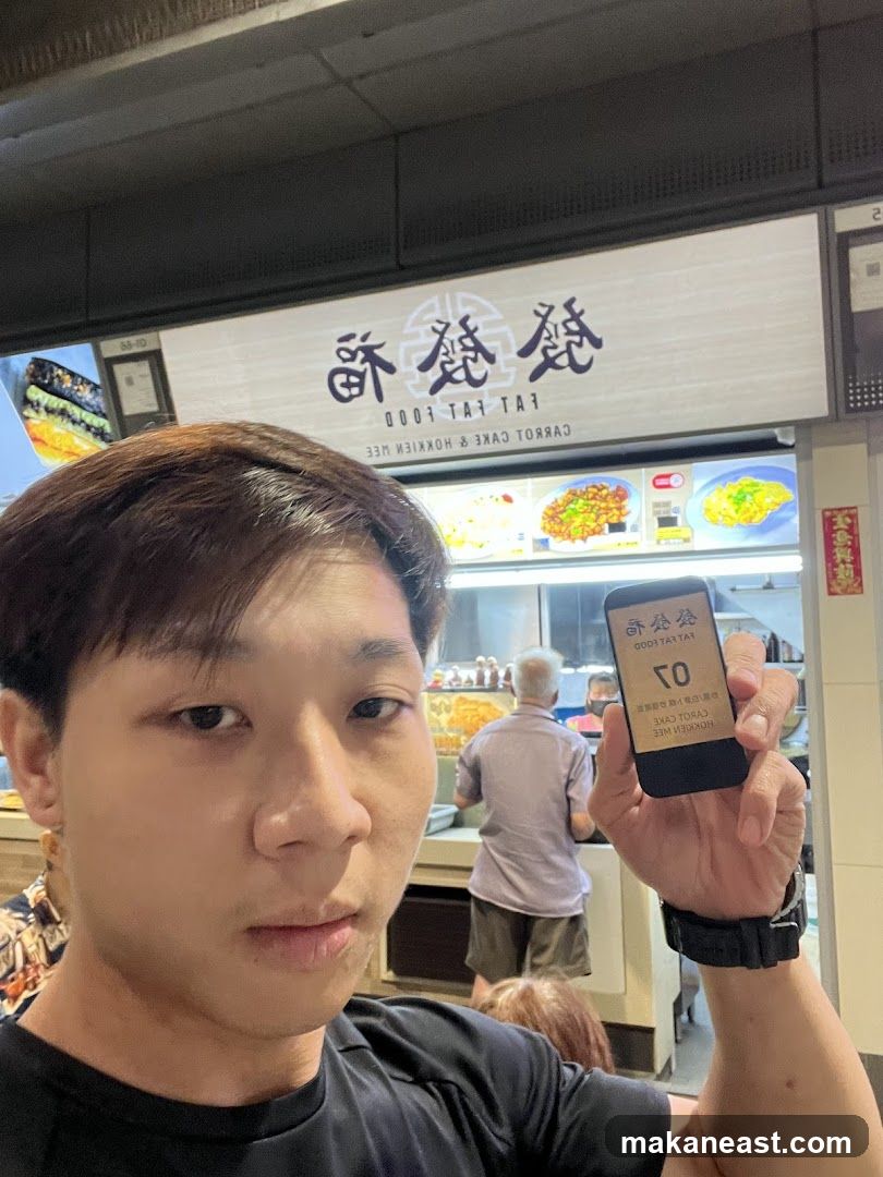 Man Holding a Buzzer at a Food Stall