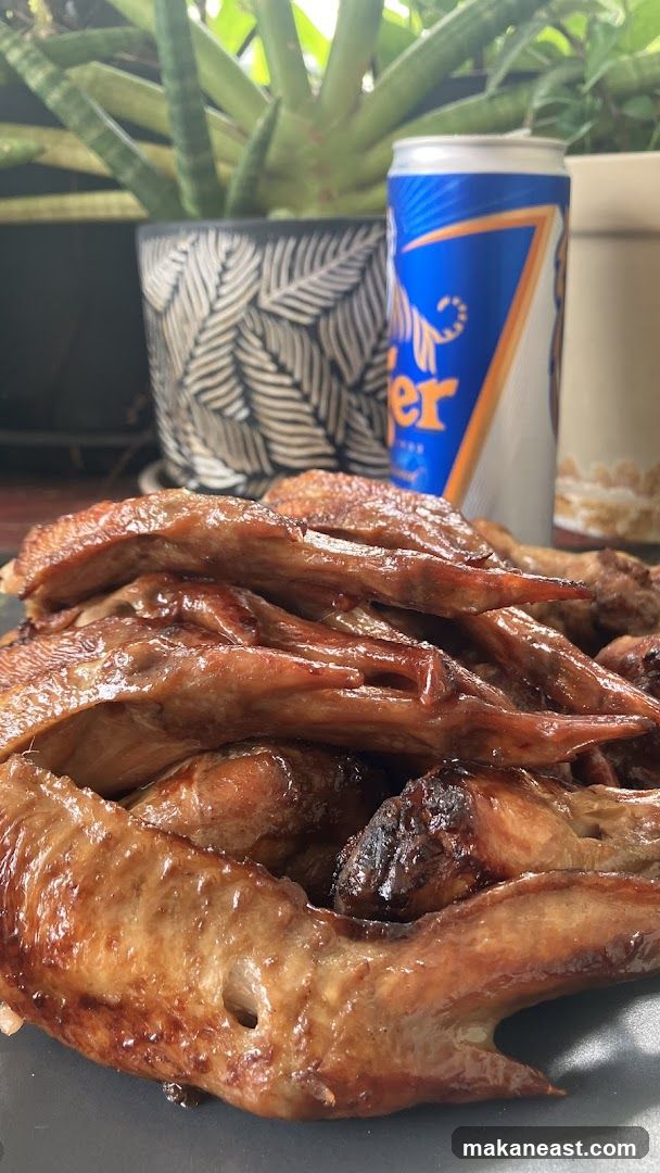 Roasted chicken wings with a can of beer