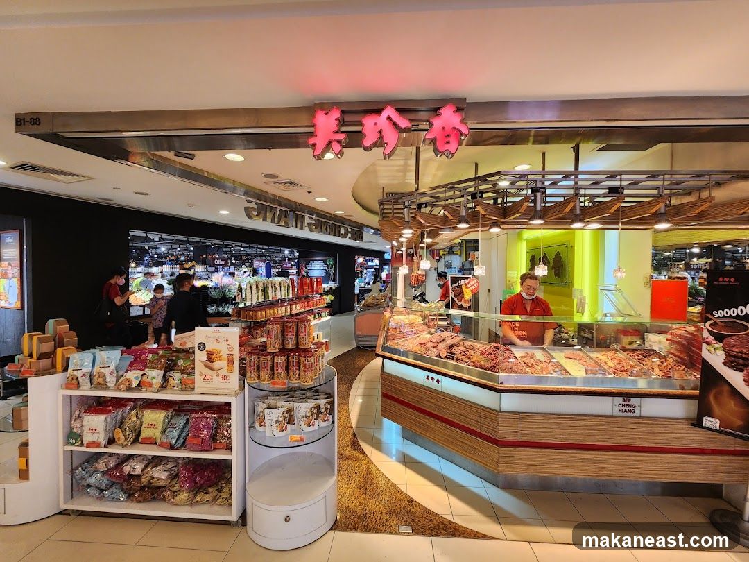 Butcher shop with meat display and packaged snacks