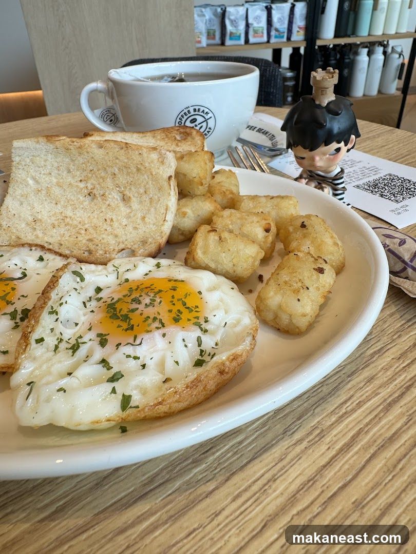 Breakfast Plate with Fried Eggs, Toast, and Tater Tots