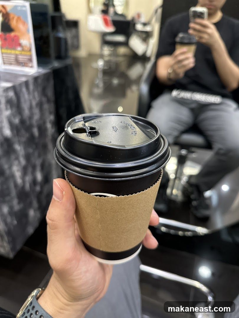 Person holding a coffee cup in a salon