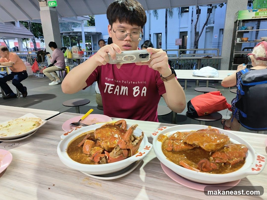 Man taking a photo of food at a hawker center