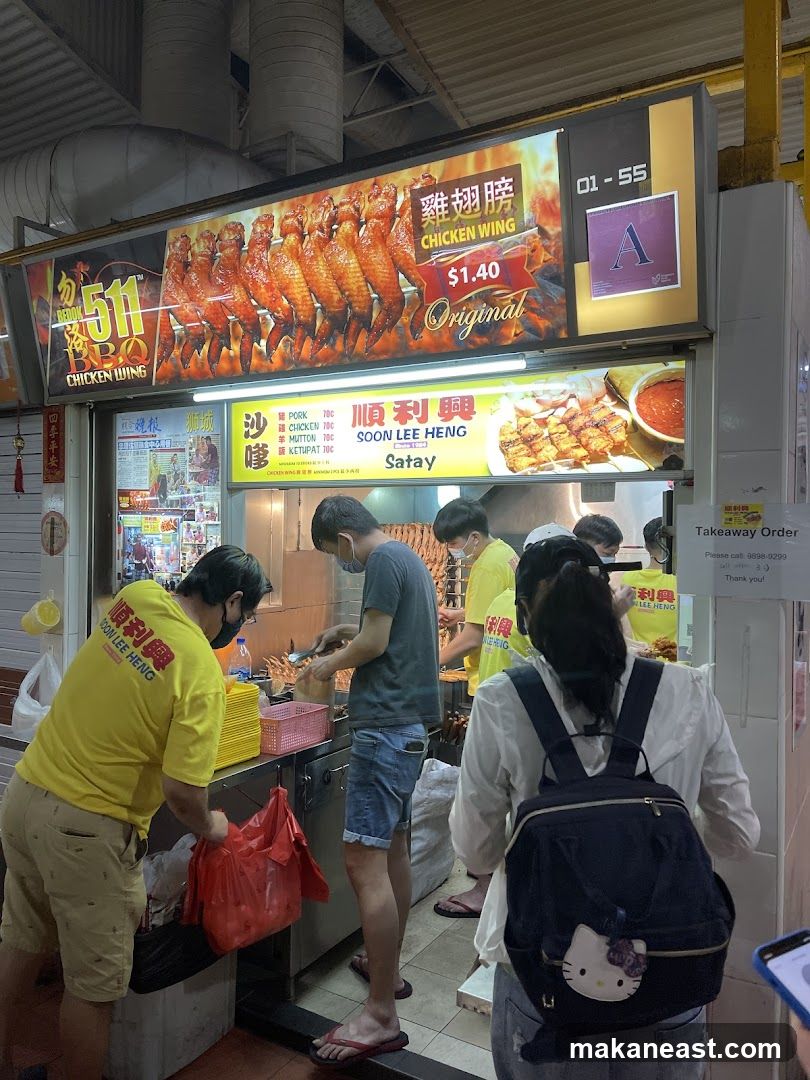 Food stall with chicken wings and satay