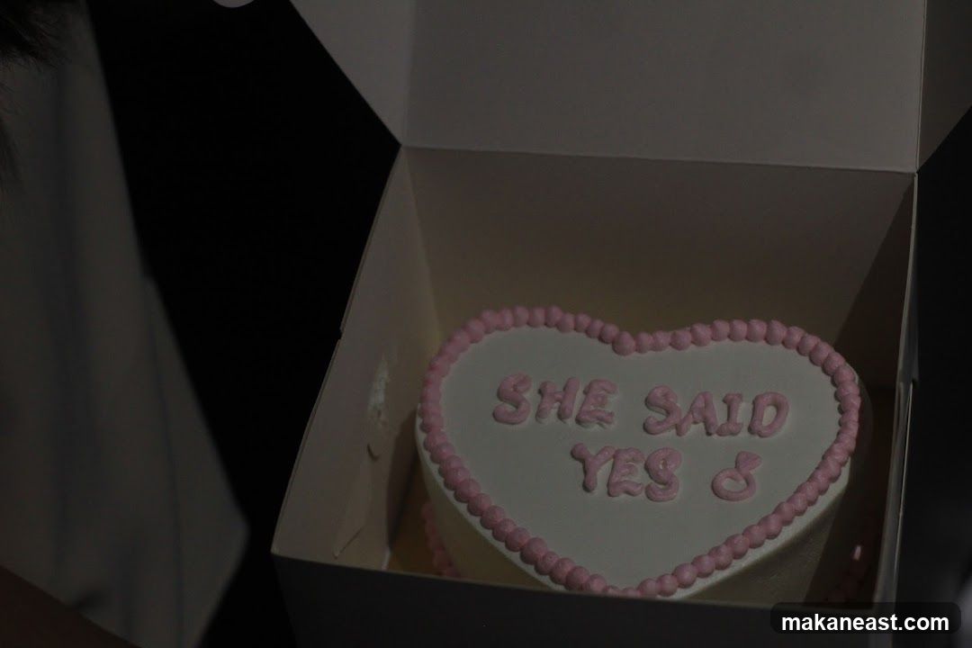 Heart-shaped cake with engagement message