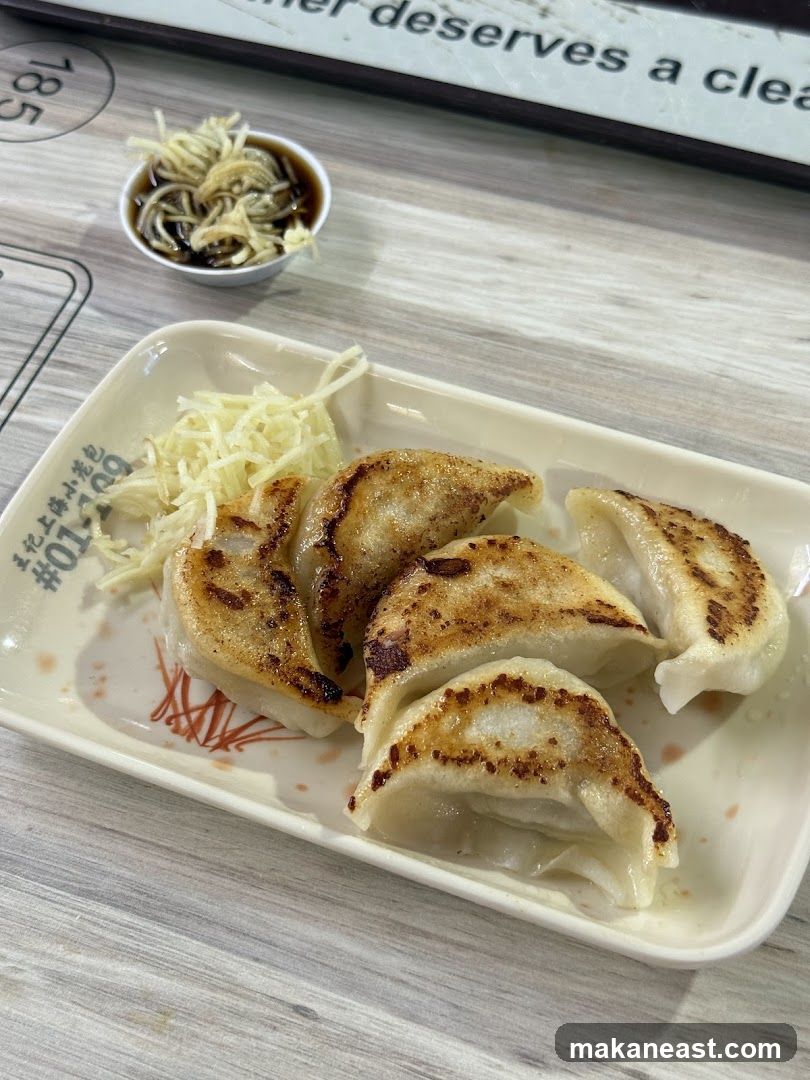 Pan-fried dumplings with shredded ginger and dipping sauce