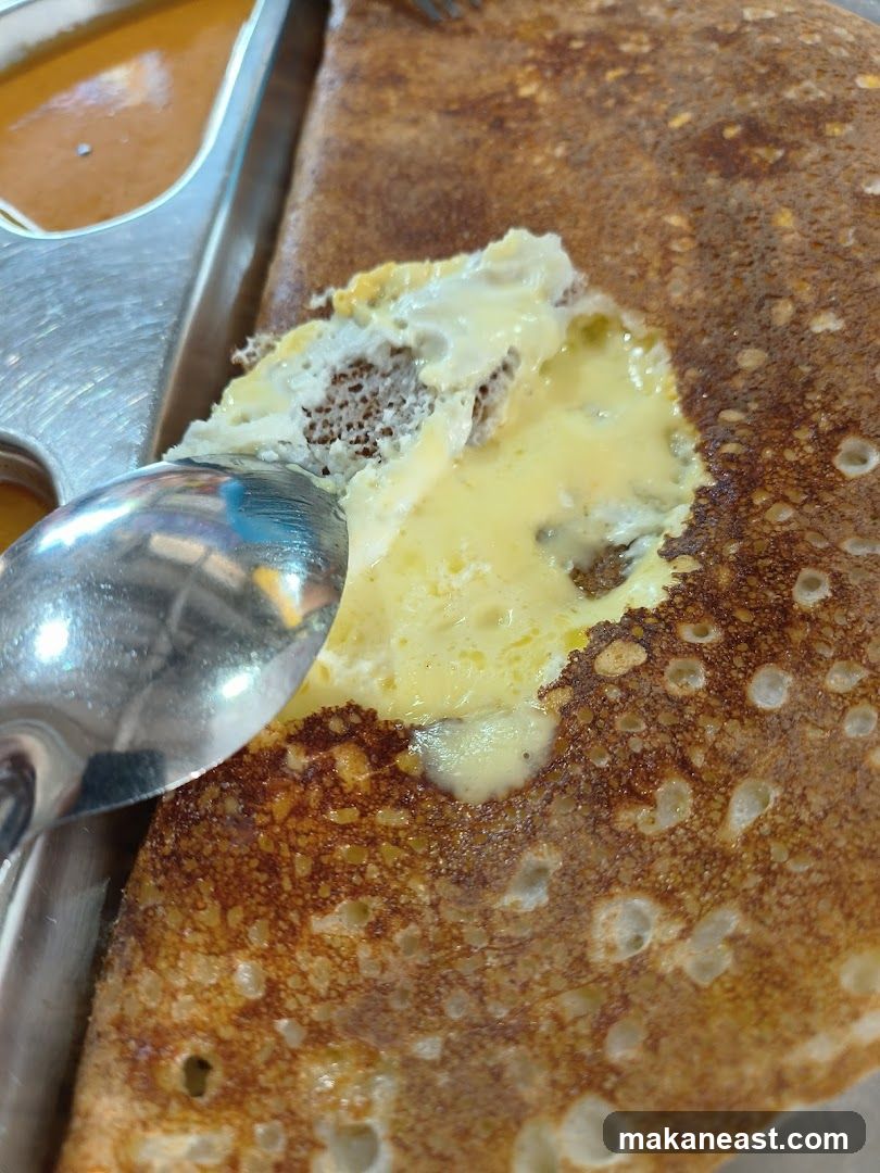 Close-up of a Dosa with Egg and Sambar
