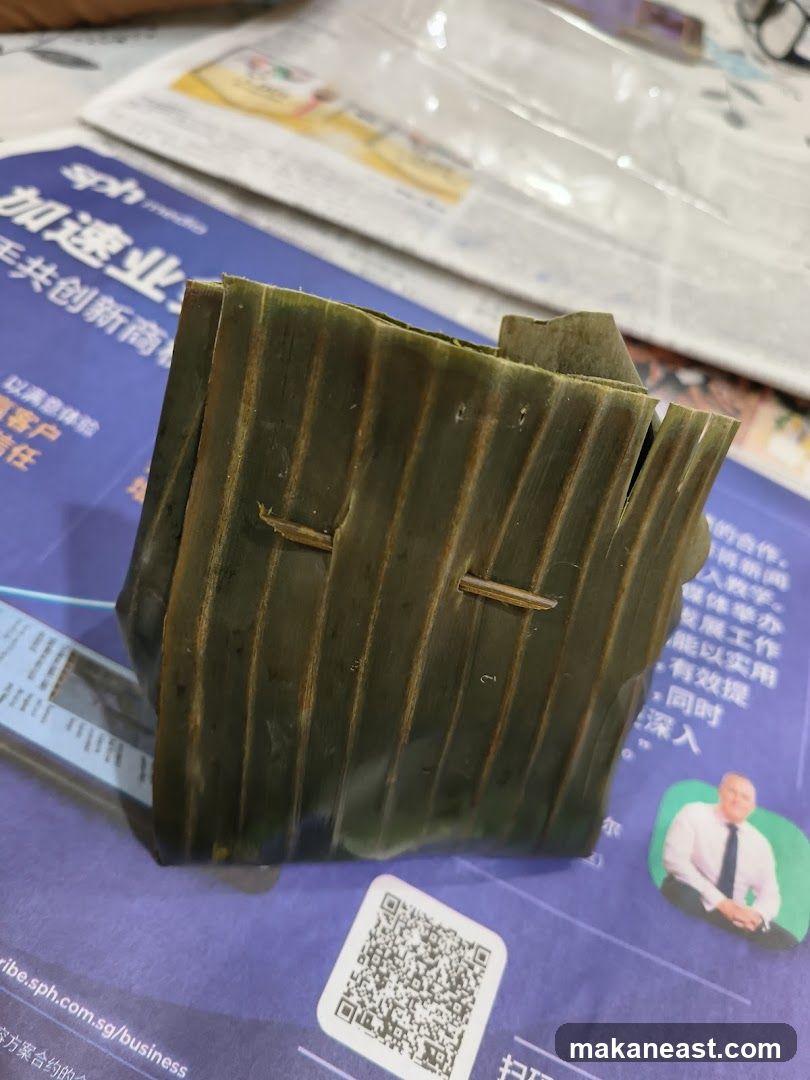 Food item wrapped in banana leaf