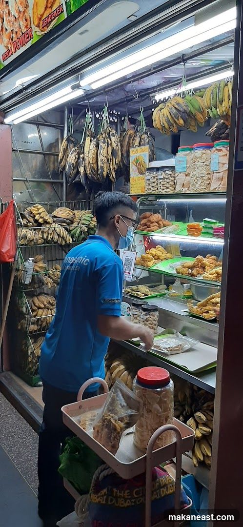 Street food stall with fried snacks and bananas