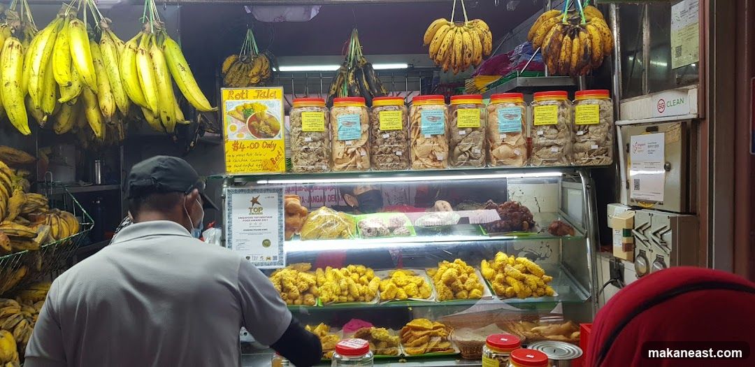 Food stall with bananas and fried snacks