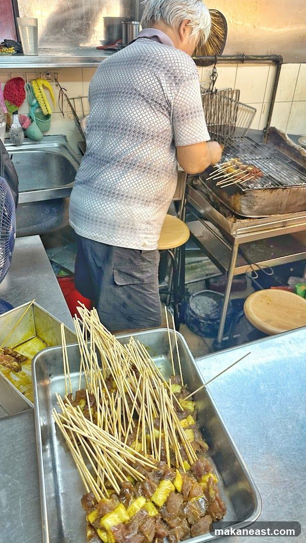 Man grilling skewers
