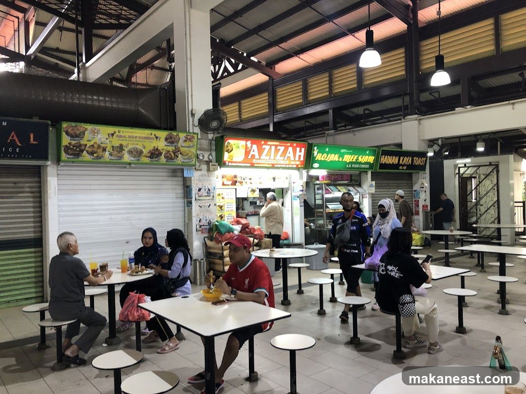 Food court with various stalls and diners