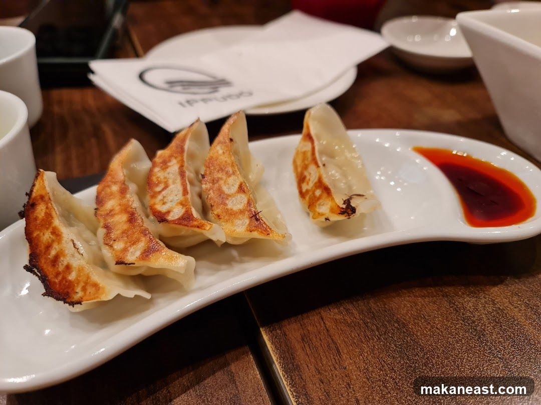 Pan-fried dumplings with dipping sauce