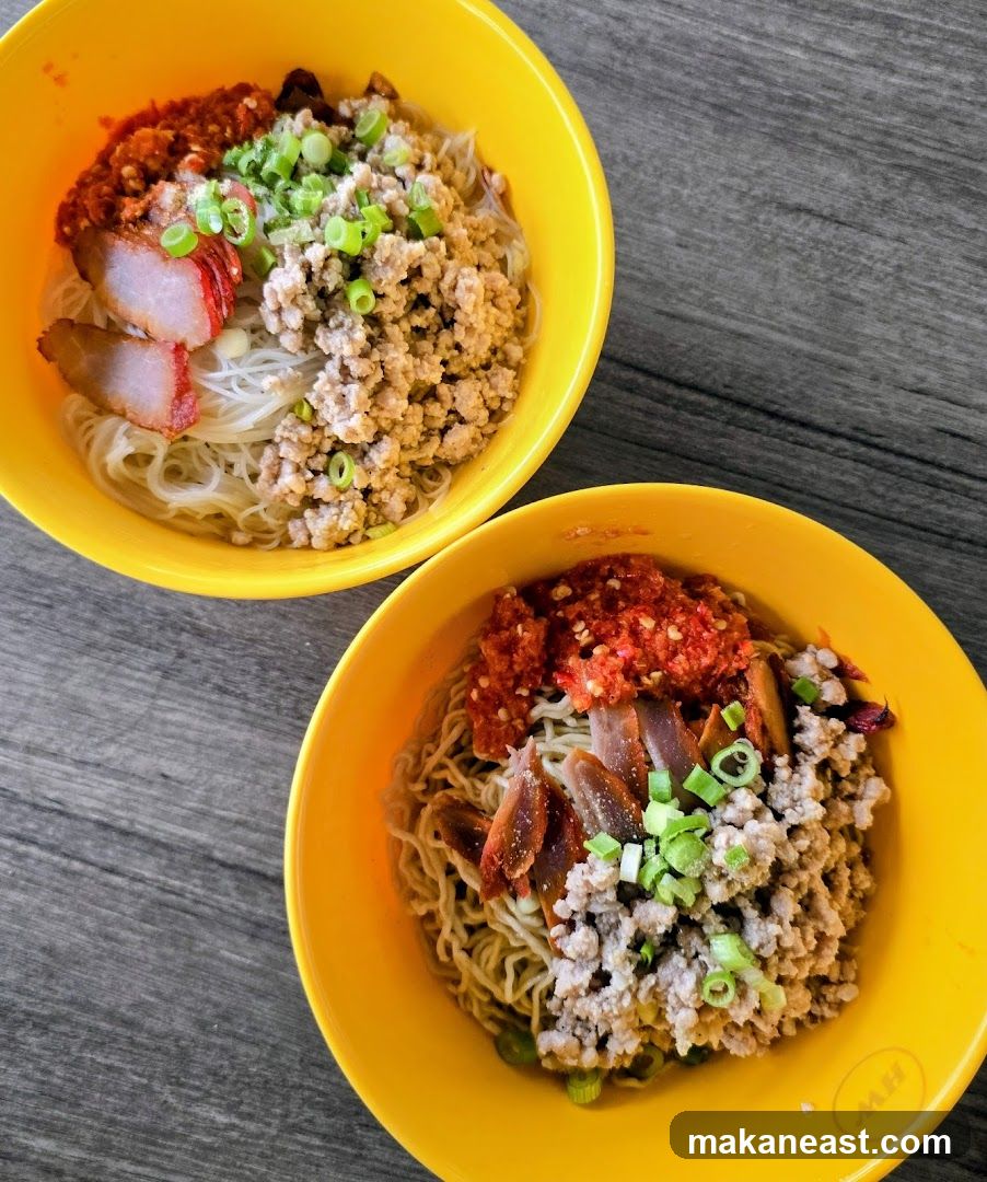 Two bowls of noodles with minced pork and chili