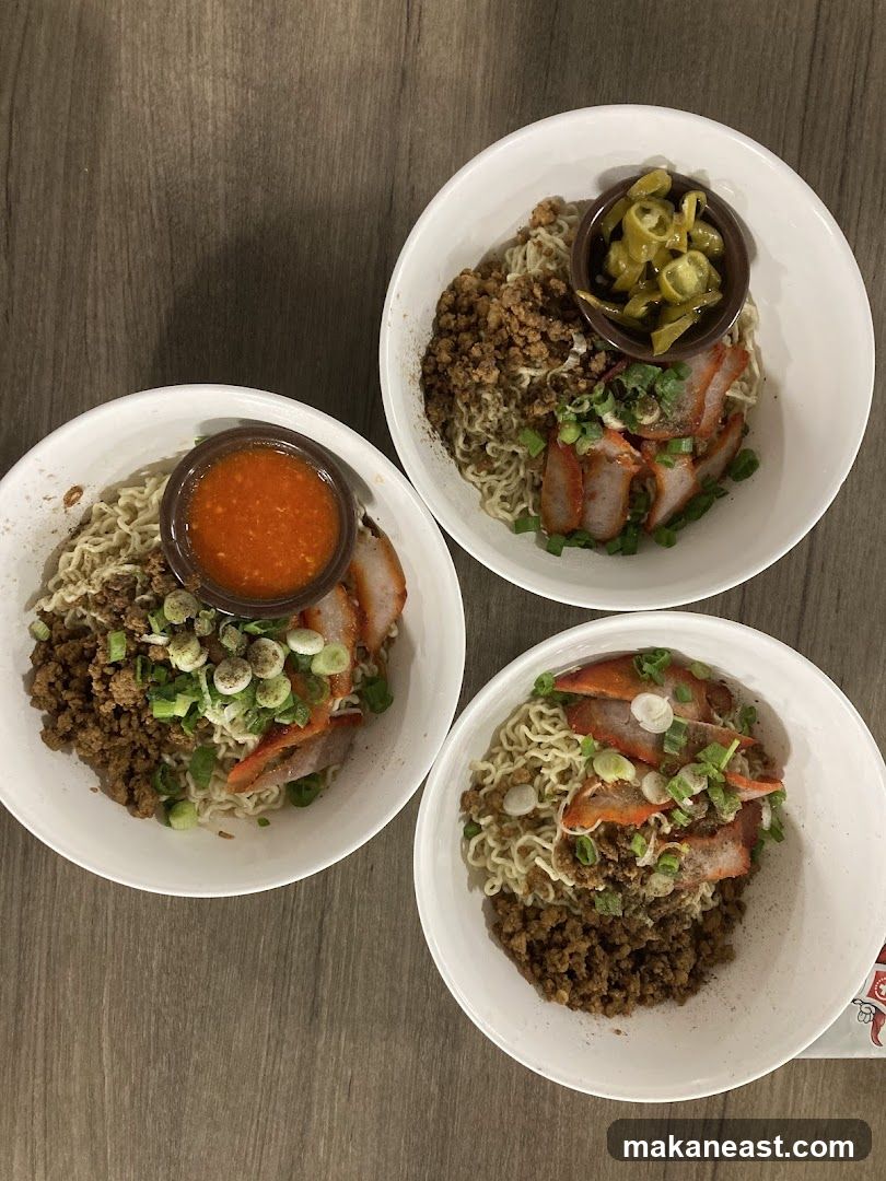 Three bowls of noodles with char siu and minced meat