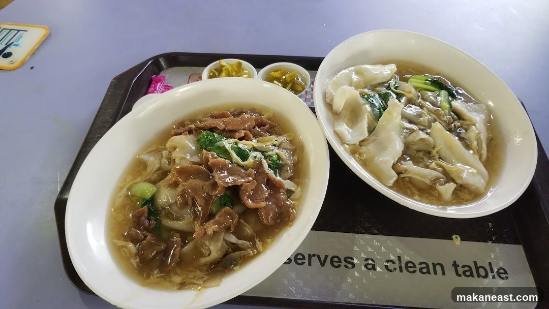 Two bowls of noodles with meat and vegetables