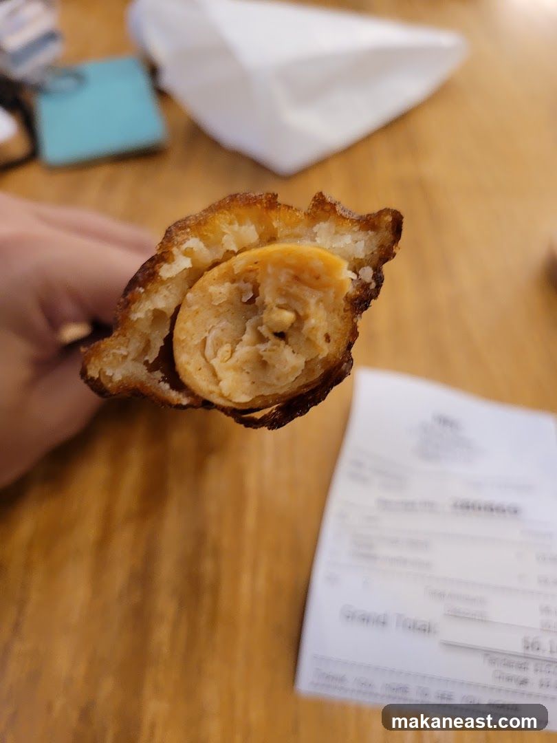 Deep-fried sausage on a stick with receipt