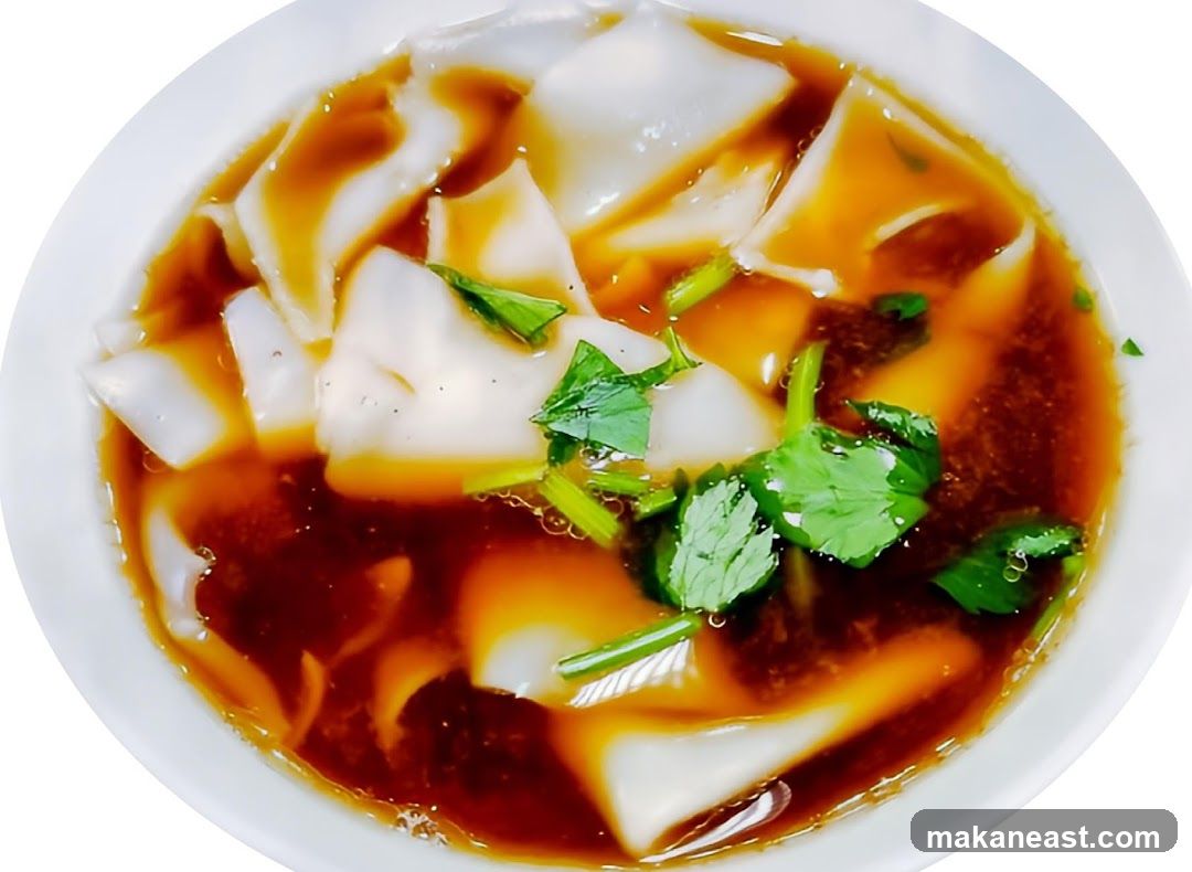 Bowl of Noodles with Sauce and Garnish