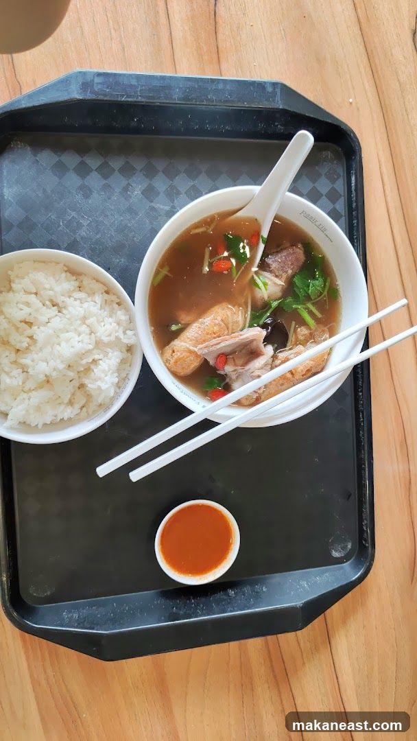 Bowl of soup with rice and dipping sauce