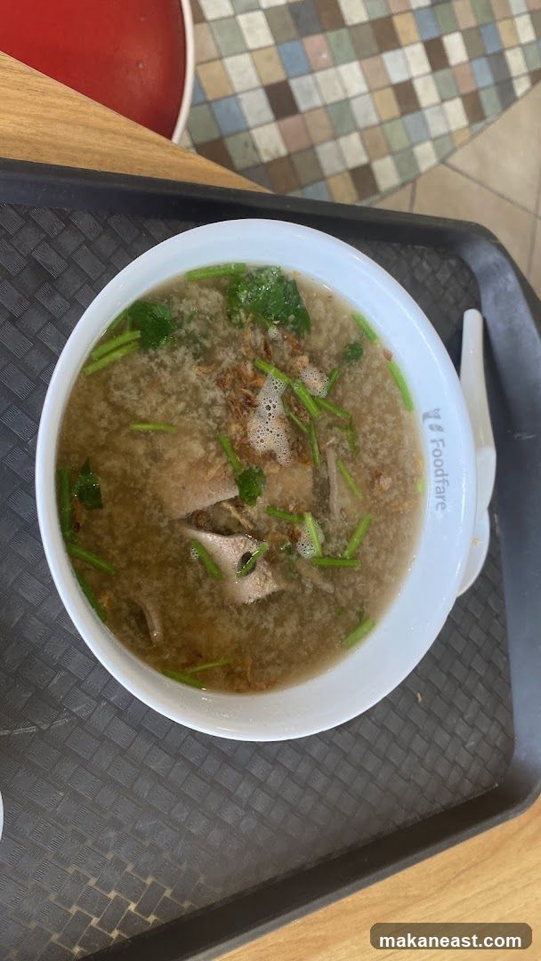 Bowl of soup with meat and greens