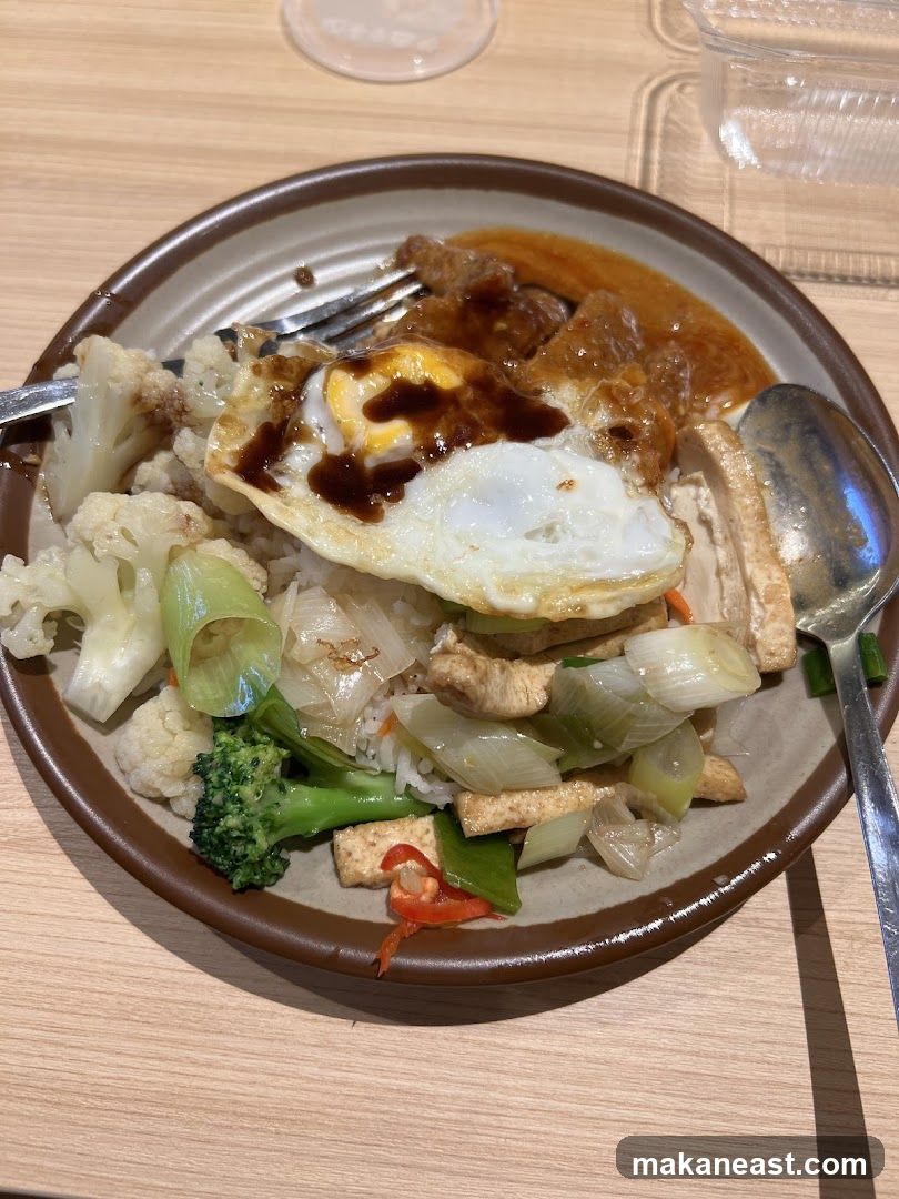 Rice dish with fried egg and vegetables