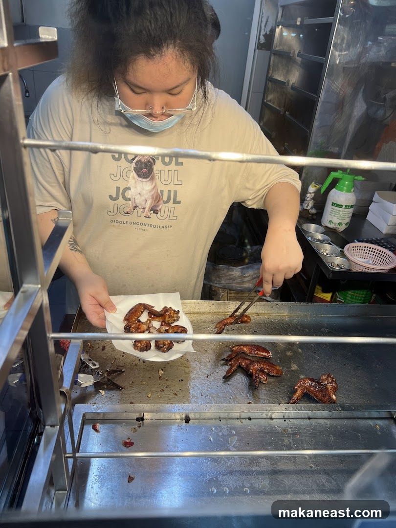 Person preparing chicken wings