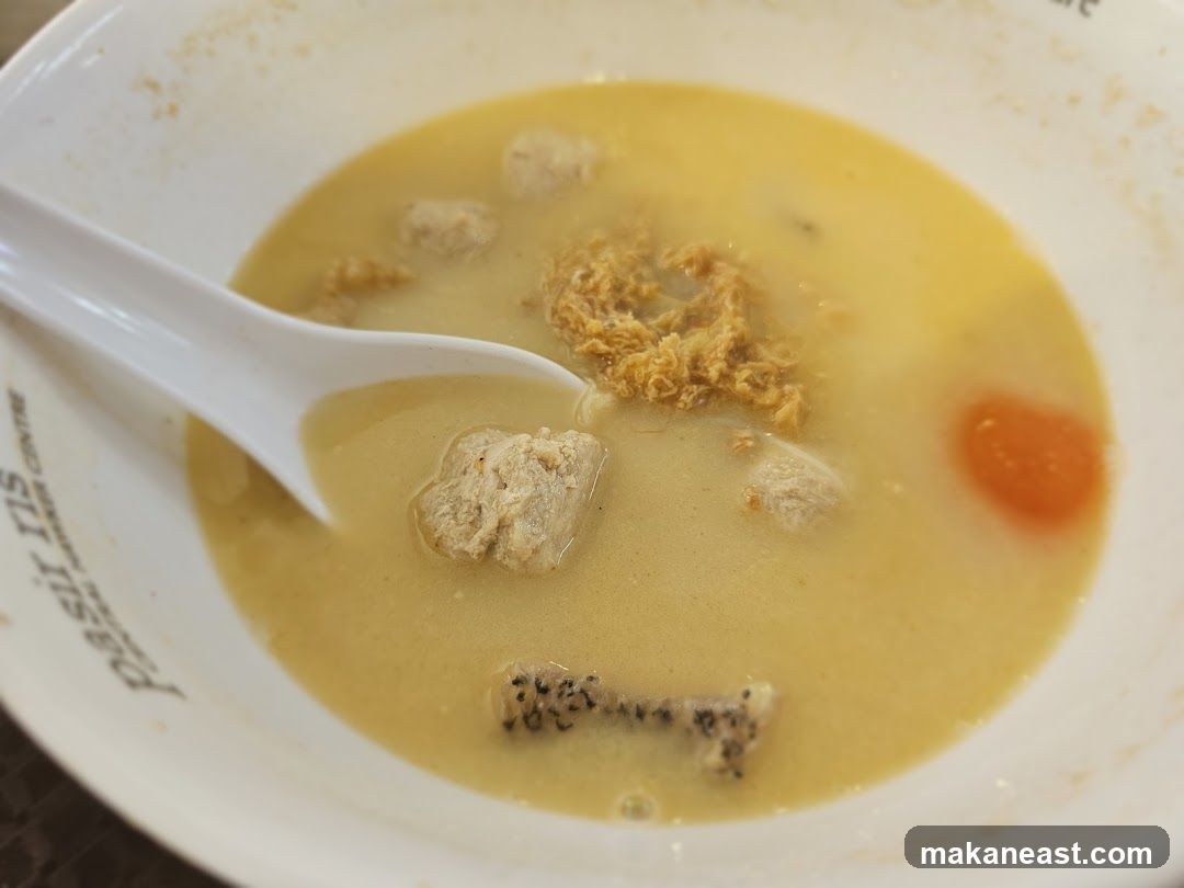 Bowl of Soup with Meatballs and Egg Yolk